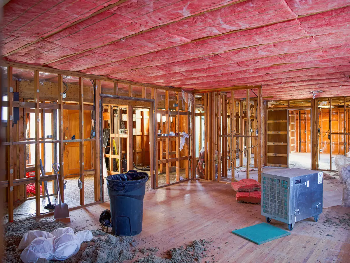 Batt insulation between ceiling joists above open wood framing
